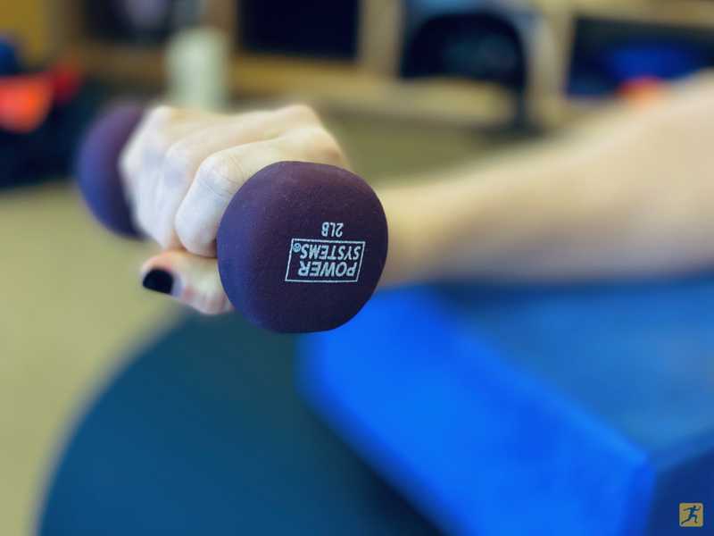 Woman exercising her wrists with hand weights